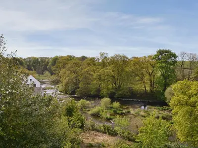 a view of a river with trees at Burnfoot Of Cluden in Holywood