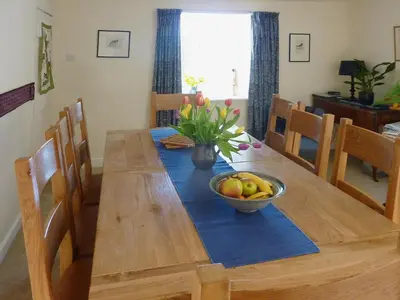 a wooden table with a bowl of fruit on it at Little Boreland in Gatehouse of Fleet