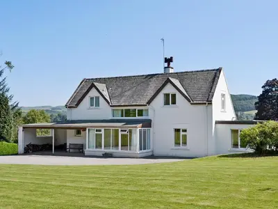 a large white house with a large yard at Mountain Cross in Gatehouse of Fleet