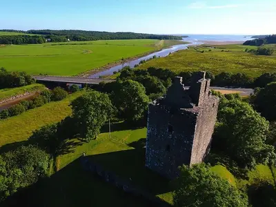 an aerial view of a castle and a river at Mountain Cross in Gatehouse of Fleet