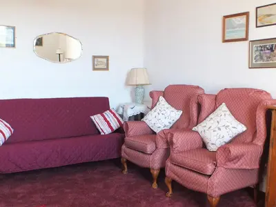 a living room with two chairs and a couch at Olafs Cottage in Garlieston