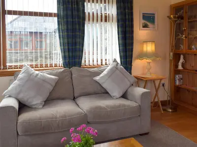 a living room with a gray couch with pillows at Quiet in Whauphill