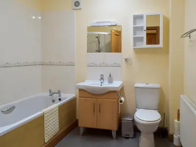 a bathroom with a sink and a toilet and a tub at Quiet in Whauphill
