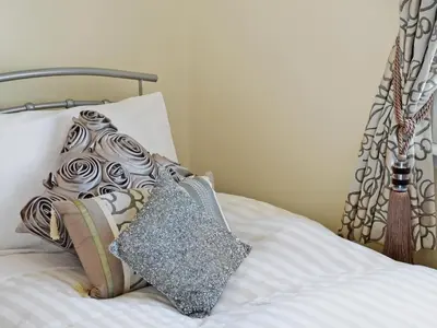 a bed with two pillows on top of it at Winloma in Port William