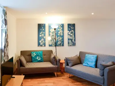 a living room with two couches and a tv at The Hen Hoose in Creebridge