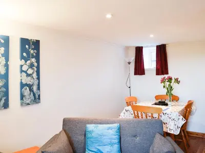 a living room with a couch and a table at The Hen Hoose in Creebridge