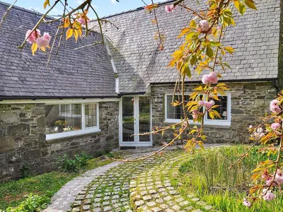 a stone house with a pathway leading to it at Holly Cottage - 28140 in Boreland of Colvend