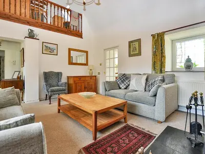 a living room with a couch and a table at Holly Cottage - 28140 in Boreland of Colvend