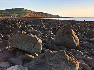 a group of rocks on a rocky beach at Rose Cottage - 28176 in Fairgirth