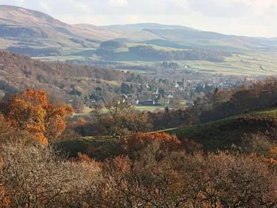 a view of a valley with trees and mountains at Myrtle Cottage - 28177 in Fairgirth