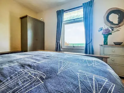 a bedroom with a bed with a drawing on it at Gigha in Drummore