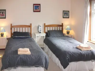 two beds sitting next to each other in a bedroom at Gigha in Drummore