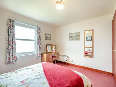 a bedroom with a bed and a window at Jura in Drummore