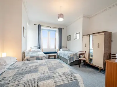 a bedroom with two beds and a window at Braefield in Portpatrick