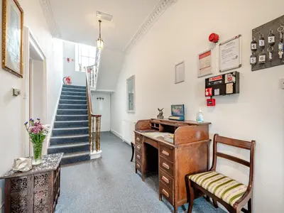 an office with an old desk and a staircase at Braefield in Portpatrick
