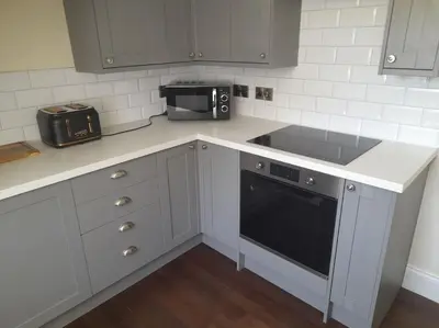 a kitchen with a counter with a sink and a microwave at Kirkcudbright Holiday Apartments - Apartment G in Kirkcudbright
