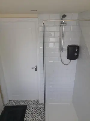 a shower with a glass door in a bathroom at Kirkcudbright Holiday Apartments - Apartment G in Kirkcudbright