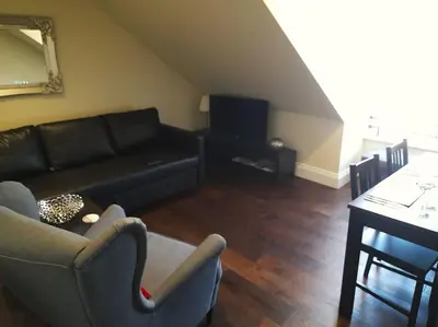 a living room with a couch and a table at Kirkcudbright Holiday Apartments - Apartment G in Kirkcudbright