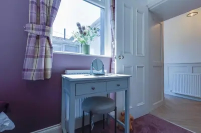 a room with a desk with a mirror and a window at Westview in Newton Stewart