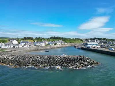 a body of water with a pier and houses at Westview in Newton Stewart