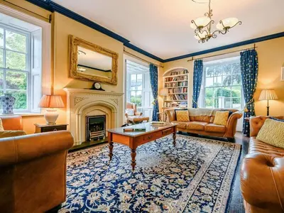 a living room filled with furniture and a fireplace at Oak Lodge in Keswick
