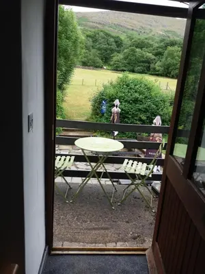 a view of a table and chairs from a door at NEWFIELD INN in Broughton in Furness