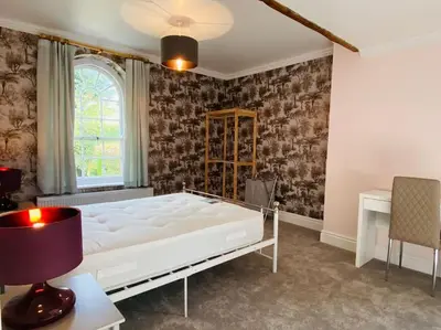 a bedroom with a large white bed and a window at Unique Country Estate nr Mountains & Beach in Silloth