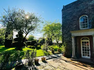 a brick house with a garden in front of it at Unique Country Estate nr Mountains & Beach in Silloth