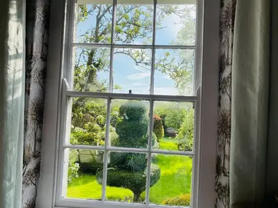 an open window with a view of a garden at Unique Country Estate nr Mountains & Beach in Silloth