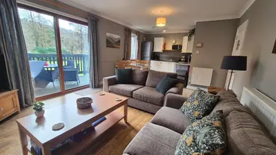 a living room with a couch and a table at The Chalets in Eskdale
