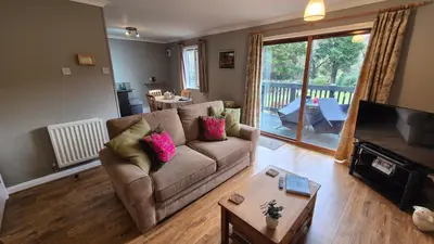 a living room with a couch and a table at The Chalets in Eskdale
