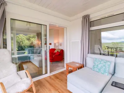 a living room with a couch and a view of a bedroom at Knockendoch in Dumfries