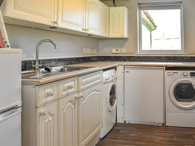 a kitchen with a sink and a dishwasher at Little Glengyre Farm in Kirkcolm