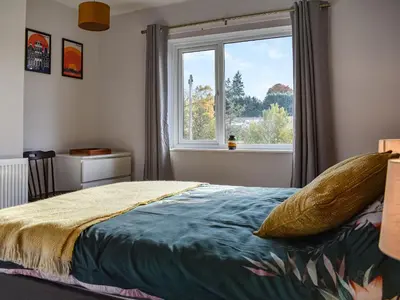 a bedroom with a bed and a window at Tynedale in Keswick