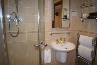 a bathroom with a sink and a shower at Riverside Escape in Keswick
