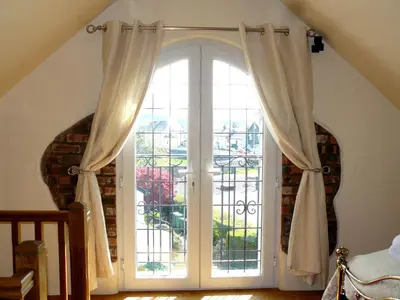 an open door with curtains in a room at Riverside Escape in Keswick