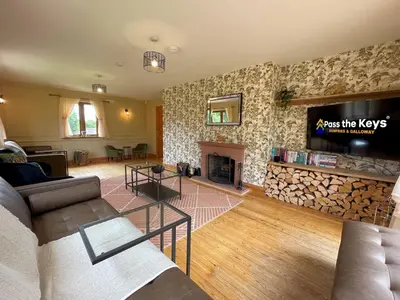 a living room with a fireplace and a tv at Spectacular 7BR House Hot Tub and Gardens in Gretna - Pass the Keys in Gretna Green