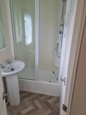 a bathroom with a shower and a sink at Serenity in Monreith