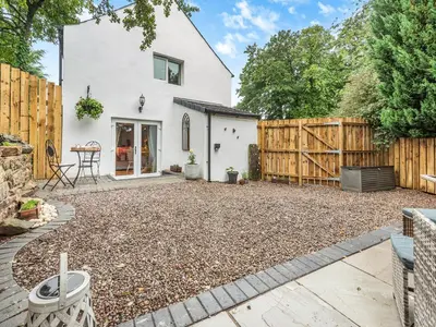a backyard with a wooden fence and a house at The Nook - Uk44735 in Tallentire