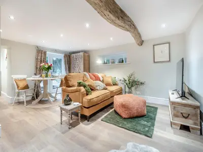 a living room with a couch and a table at The Nook - Uk44735 in Tallentire