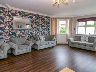 a living room with two couches and a mirror at Fern Lee in Carlisle