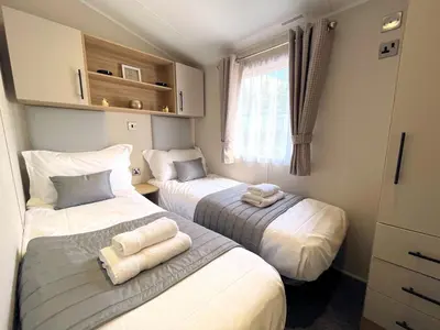 a bedroom with two beds with towels on them at Gorgeous Kippford Home With Outstanding Views - Pass the Keys in Kippford