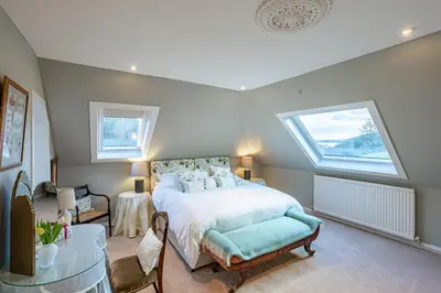 a bedroom with a bed and a large window at Kenmure Kennels in New Galloway