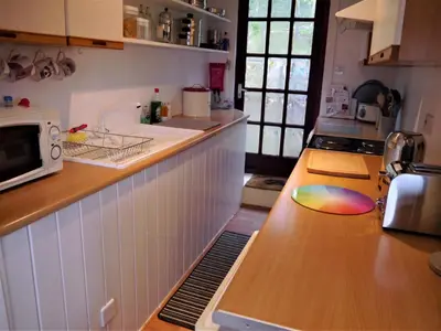 a kitchen with a counter with a sink and a microwave at Kippford Stables in Kippford