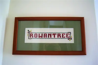 a framed picture of a round perimeter sign on a wall at Rowantree Cottage in Gatehouse of Fleet