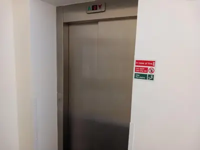 a elevator door in a building with a sign on it at Harbourside Apartment - 1 Bedroom - Sleeps 2 in Whitehaven