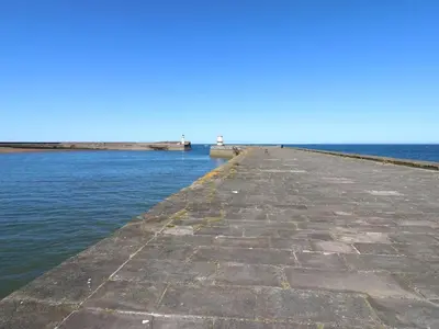 a pier stretches out into the water at Harbourside Apartment - 1 Bedroom - Sleeps 2 in Whitehaven