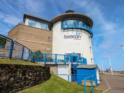 a building with a beacon sign on the side of it at Harbourside Apartment - 1 Bedroom - Sleeps 2 in Whitehaven