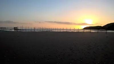 a sunset on the beach with the sun setting at Portling View in Dalbeattie