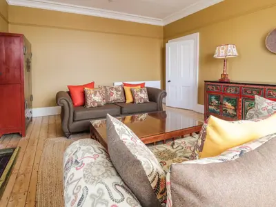 a living room with two couches and a table at Auchenvhin - Rockcliffe in Dalbeattie